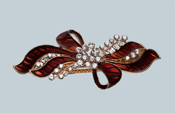 A bow with jewelry stones with a grey background.
