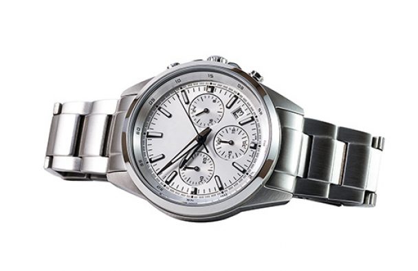 A watch on display with a grey background.